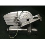 A stainless steel commercial meat slicer