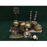 A tray of assorted brass ware - flat irons, candlesticks,
