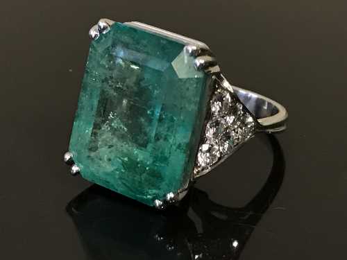 An impressive white gold, emerald and diamond set ring,