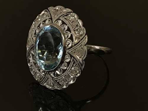 A white gold diamond and aquamarine cluster ring, the aquamarine estimated to weigh 4.