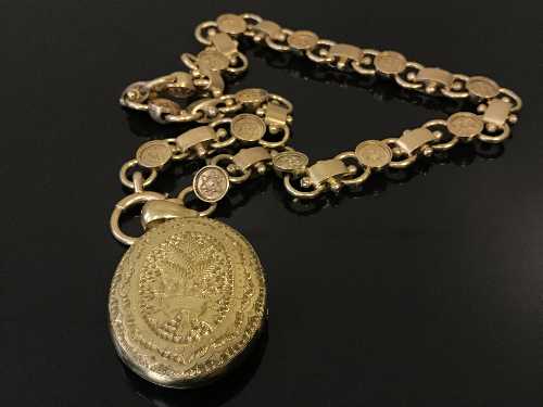 An ornate gold locket upon chain, the chain stamped '18', weight 53.