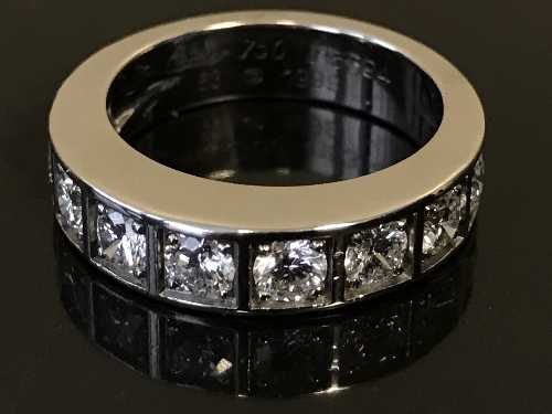 An 18ct white gold nine stone diamond half-eternity ring by Cartier,