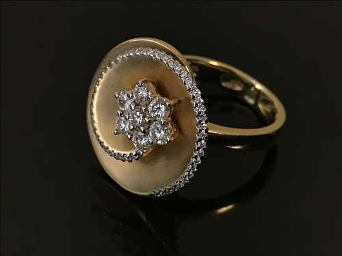 An 18ct gold and diamond set spiral cluster ring, total diamond weight estimated at 0.9 carat, 11.