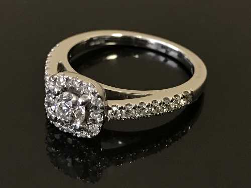 An 18ct white gold diamond cluster ring, the principal stone estimated to weigh 0.