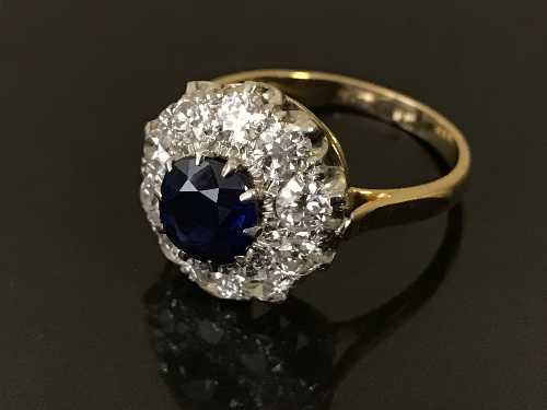 A sapphire and diamond cluster ring, the sapphire weighing an estimated 1.