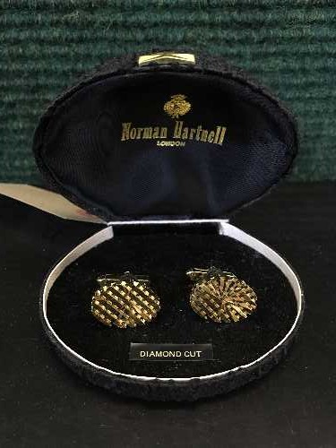 A pair of vintage Norman Hartnell diamond-cut cufflinks, in original box.