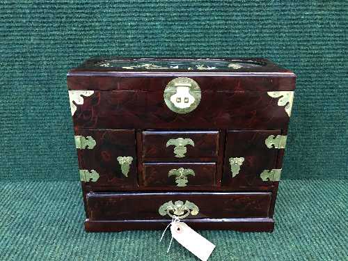 An Oriental style lacquered jewellery casket fitted with drawers,