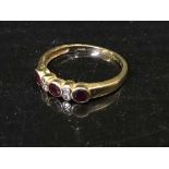 An 18ct gold three stone ruby and diamond set ring