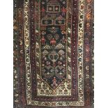 An early twentieth century fringe Persian rug on multicoloured ground and medallion borders.