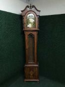 A reproduction regulator clock in inlaid walnut case