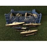 Two baskets of battle ships and submarines on stands together with a crate of die cast and other