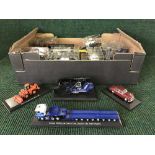 A box of die cast vehicles including fire trucks, police cars,
