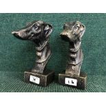 Two cast metal Greyhound heads on stands (2)