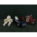 A cast metal figure - Michelin man on bike together with a Michelin racing car