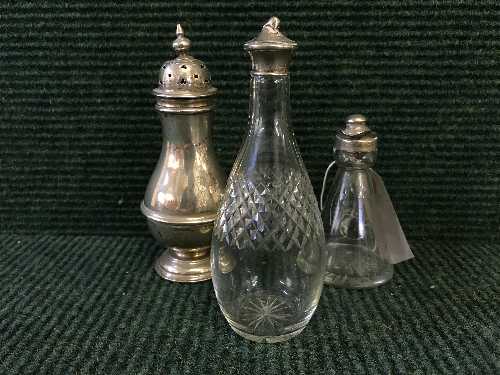 A sterling silver sugar sifter and two silver topped bottles