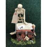 A novelty cast metal money bank - Skeleton
