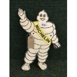 A cast metal plaque Michelin man