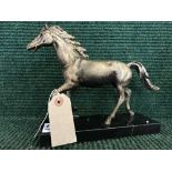 A cast metal horse figure on marble base