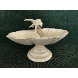 A cast metal bird bath