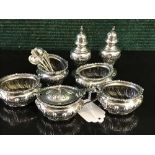 A seven piece silver cruet set by Walker & Hall, Sheffield 1901, with five matching spoons, 11.