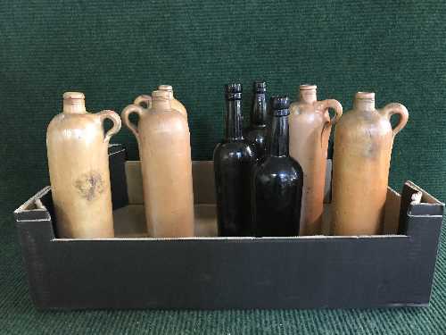 A box of stoneware bottles