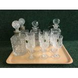 A tray of crystal and four decanters