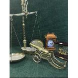 A large set of brass scales, a brass miniature cannon,