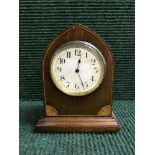 A mahogany mantel clock on brass bracket feet