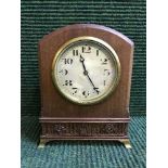 An inlaid mahogany arched topped mantel clock