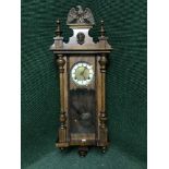 A mahogany cased Vienna wall clock with pendulum