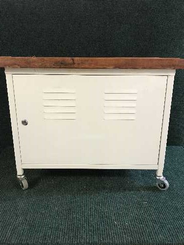 A metal storage trolley with pine top together with a floor lamp