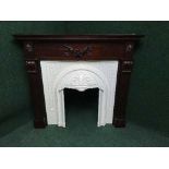 A decorative mahogany fire surround with a fibre glass Adams style insert