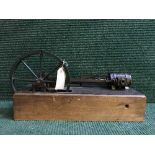 A hand-built steam piston engine on wooden stand