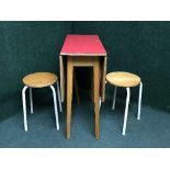 A melamine topped table and two stools