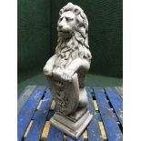 A garden figure - lion holding a shield