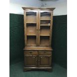 A Stag glazed door bookcase