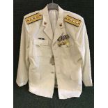 A white Chinese naval jacket with badges and medals