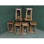 Two mahogany occasional tables and six stools