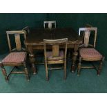 An early twentieth century oak pull out table together with six chairs