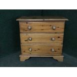 A pine three drawer chest