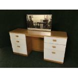 A three piece contemporary bedroom suite comprising of kneehole dressing table,