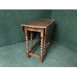 An oak barley twist gate leg table