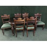A Victorian mahogany wind out table with winder and leaf and six carved dining chairs