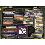 A box of Now Cds and DVDs and other compilation Cds