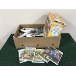 A box of Nintendo Wii console with accessories and games and a Wii Family Trainer