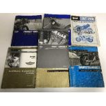 A basket of seven Buell & Harley Davison motor bike service manuals