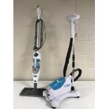 A Tobi steam cleaner together with a Shark floor steam cleaner and a kitchen pedal bin