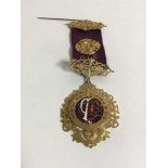 A 9ct gold and enamel Royal Order of Buffaloes medal, 'Presented to Bro George Harwood K.O.M.