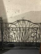 A set of ornate metal bed ends