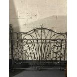 A set of ornate metal bed ends